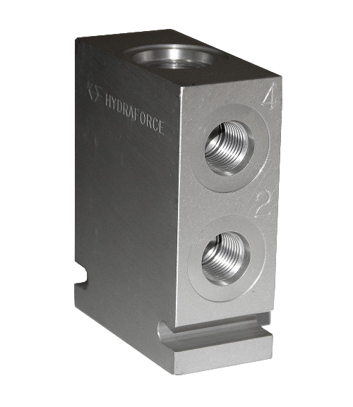 Close-up of a precision-engineered metal grease block with threaded ports, designed for use in lubrication systems, illustrating the components of automatic and manual grease lubrication systems.