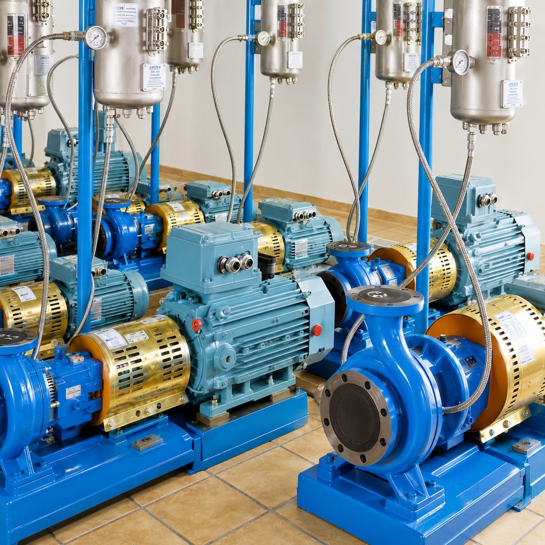 Industrial Barrier Seal Fluid Fill System featuring multiple blue and gold pumps and motors, designed for effective fluid management and sealing applications in manufacturing environments.