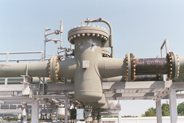 Bolted-cover strainer installed in a piping system, featuring a robust design for efficient filtration and maintenance. The image shows the strainer's connections and structural components, emphasizing its industrial application.