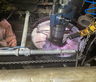 Industrial machinery with a cutting tool in operation, highlighting the prevention of 42 hours of downtime and a cost savings of $1.9 million.