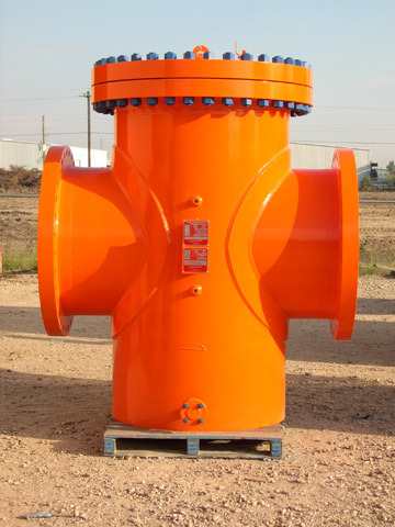 Orange pipeline basket strainer displayed outdoors, featuring multiple inlet and outlet connections, designed for efficient filtration in industrial applications.