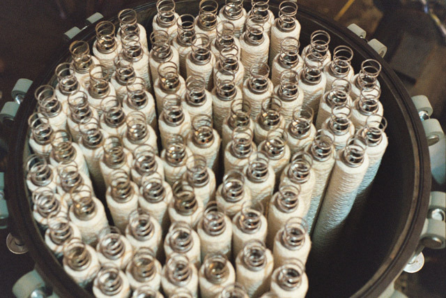 Industrial filtration products featuring numerous filter cartridges arranged in a large cylindrical container, highlighting efficient pipeline filtration solutions.