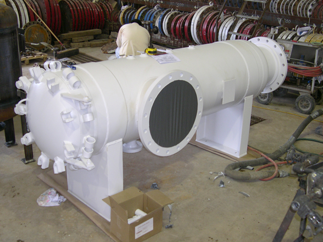 Horizontal basket strainer in a manufacturing facility, showcasing its cylindrical design, inlet and outlet ports, and a viewing window. The strainer is designed for effective filtration in industrial applications, ensuring optimal flow and system protection.