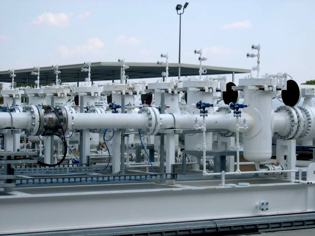 Industrial meter protection basket strainers installed on a piping system, designed to filter out debris and protect flow meters in a processing facility.