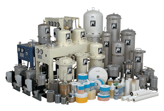Industrial filtration equipment and components, including various tanks, filters, and accessories, displayed together for testing and demonstration purposes.