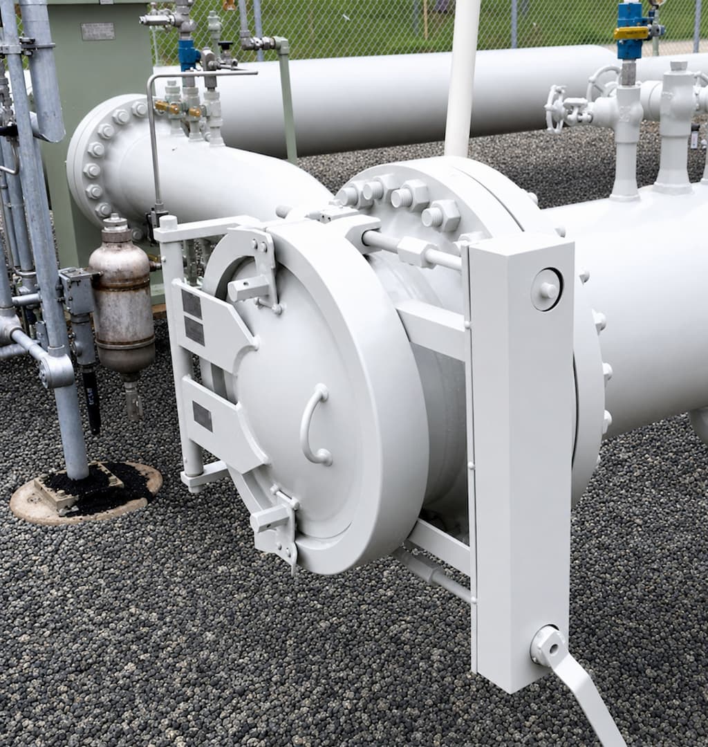 Close-up of a tube turn quick open closure mechanism on a pipeline, showcasing its design and components in an industrial setting.